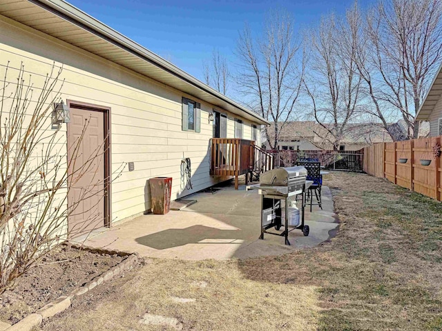 812 15 1/2 Ave SE, Minot, ND 58701 - view of patio / terrace featuring grilling area, a fenced backyard, and a wooden deck