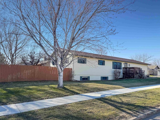 812 15 1/2 Ave SE, Minot, ND 58701 - view of front of home with fence, a deck, and a front yard