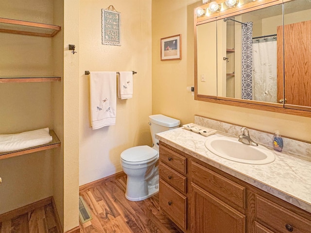 812 15 1/2 Ave SE, Minot, ND 58701 - bathroom featuring wood finished floors, vanity, a shower with shower curtain, and toilet