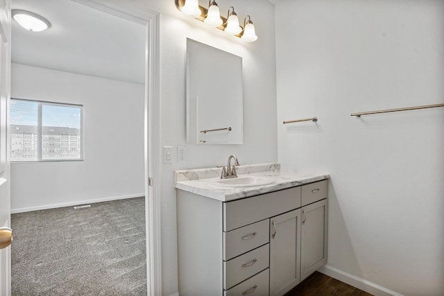 bathroom with vanity and baseboards