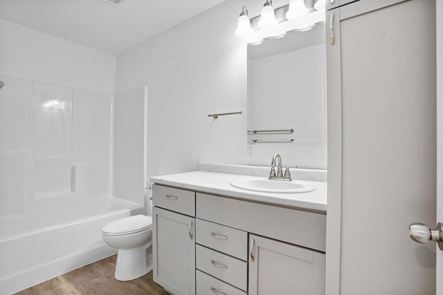 bathroom with toilet, vanity, bathtub / shower combination, and wood finished floors