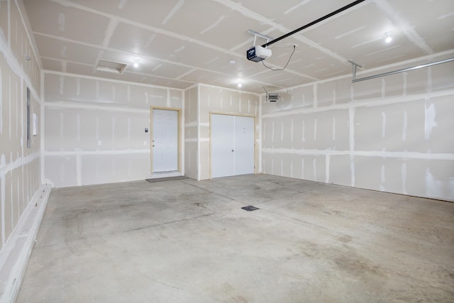 garage with visible vents and a garage door opener