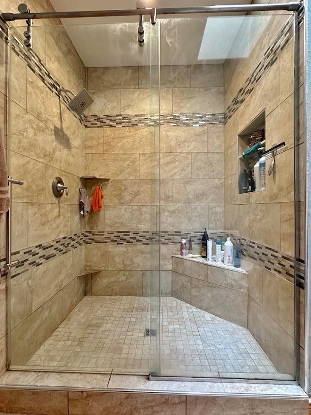 full bath with a shower stall