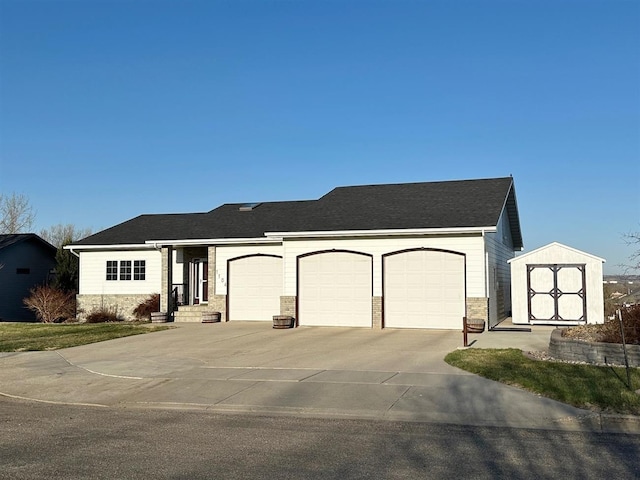 ranch-style house featuring concrete driveway and an attached garage