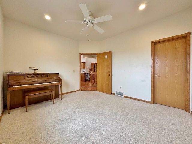 living area featuring visible vents, ceiling fan, carpet, and baseboards