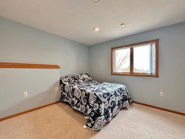 bedroom featuring recessed lighting, a textured ceiling, carpet flooring, and baseboards