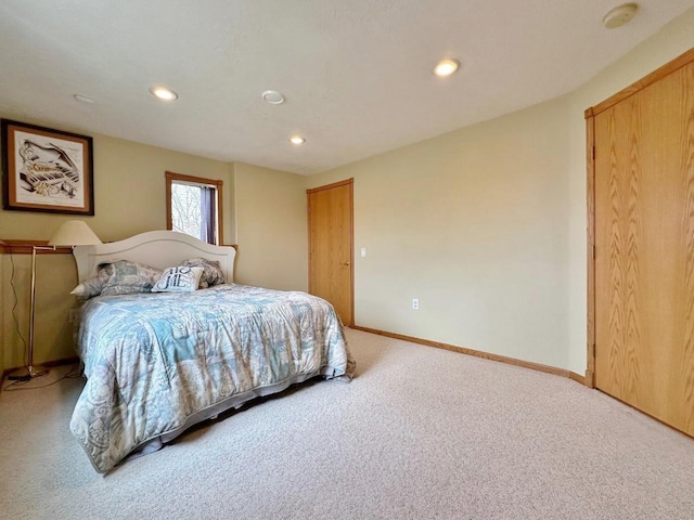 bedroom with recessed lighting, baseboards, and light carpet