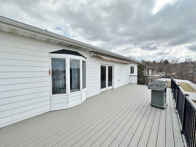 wooden terrace featuring a grill