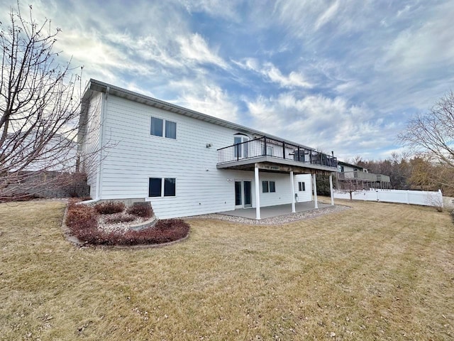 back of property with fence, a patio area, a yard, and a wooden deck