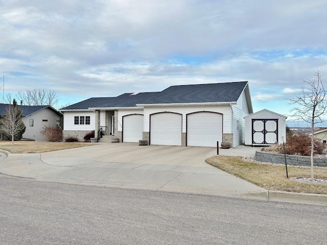 ranch-style home with concrete driveway, stone siding, a garage, and a shingled roof