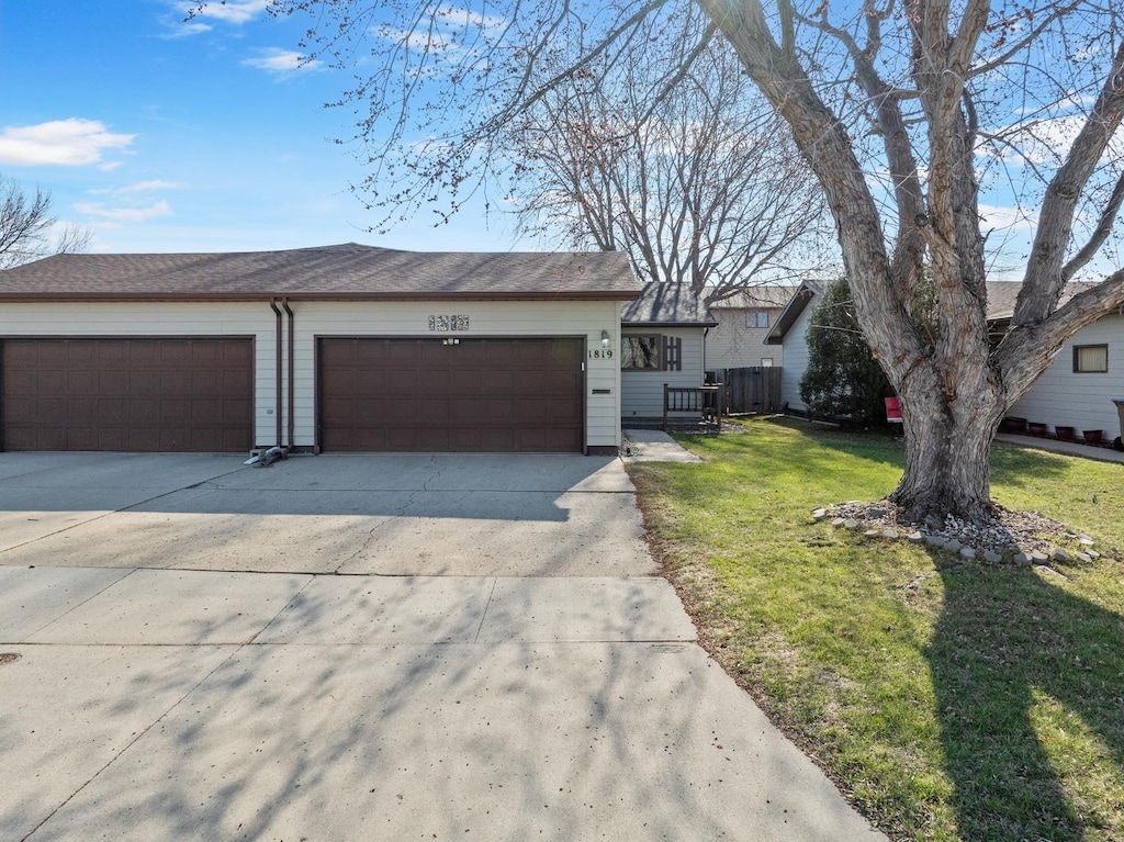 1819 SW 15 1/2 St, Minot, ND 58701 - view of front of property featuring concrete driveway, a front yard, and a garage