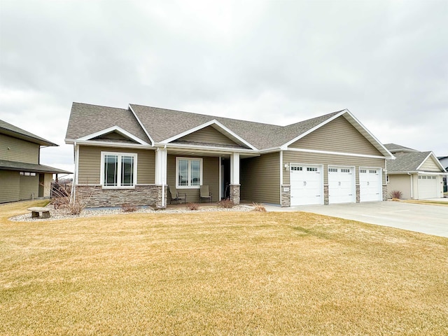 craftsman inspired home featuring stone siding, driveway, roof with shingles, a front yard, and an attached garage