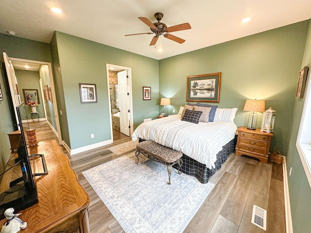 bedroom with recessed lighting, light wood-type flooring, ensuite bathroom, baseboards, and visible vents