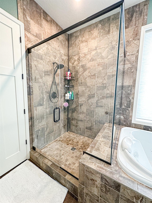 full bathroom featuring a stall shower and a jetted tub