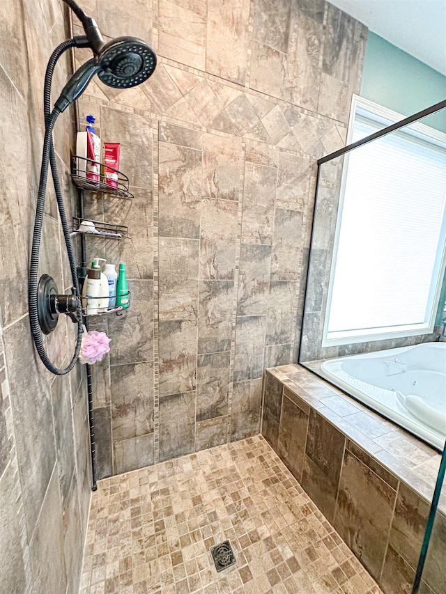 bathroom with a relaxing tiled tub and tiled shower