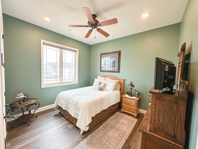 bedroom with wood finished floors, ceiling fan, recessed lighting, and baseboards