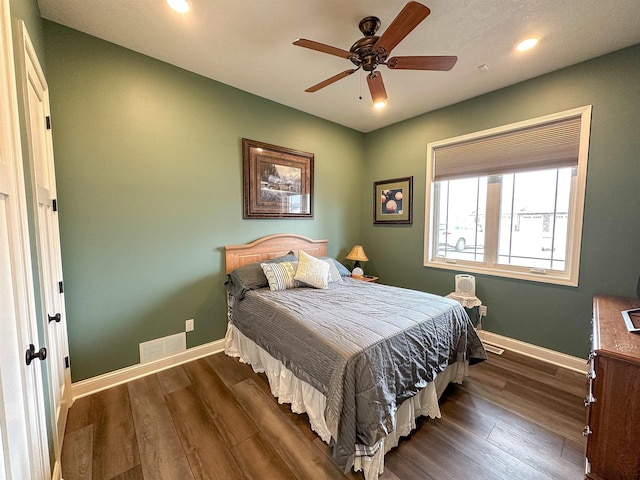 bedroom with recessed lighting, visible vents, dark wood-style flooring, and baseboards