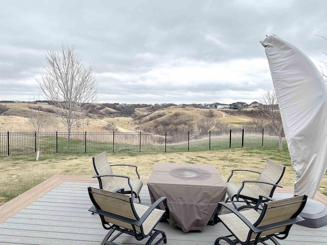 wooden terrace with a lawn and a fenced backyard