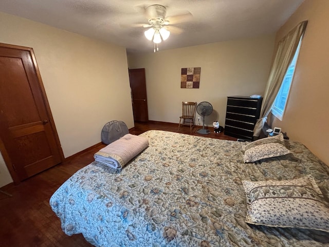 402 Brewster St, Harvey, ND 58341 - bedroom featuring baseboards, wood finished floors, and a ceiling fan