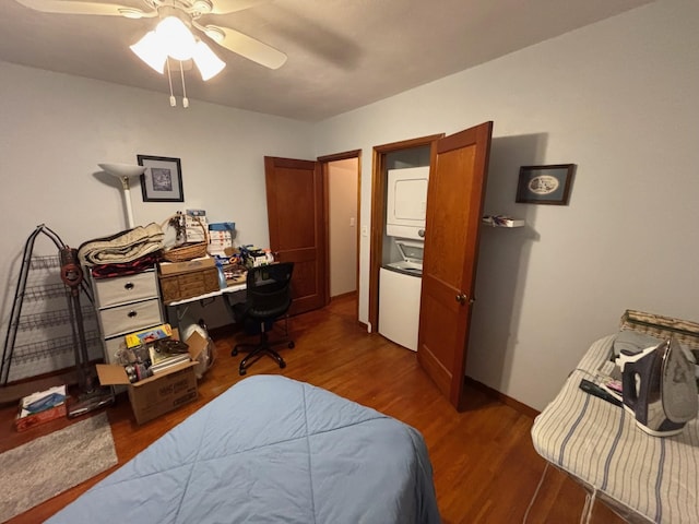 402 Brewster St, Harvey, ND 58341 - bedroom with stacked washer / dryer, ceiling fan, and wood finished floors