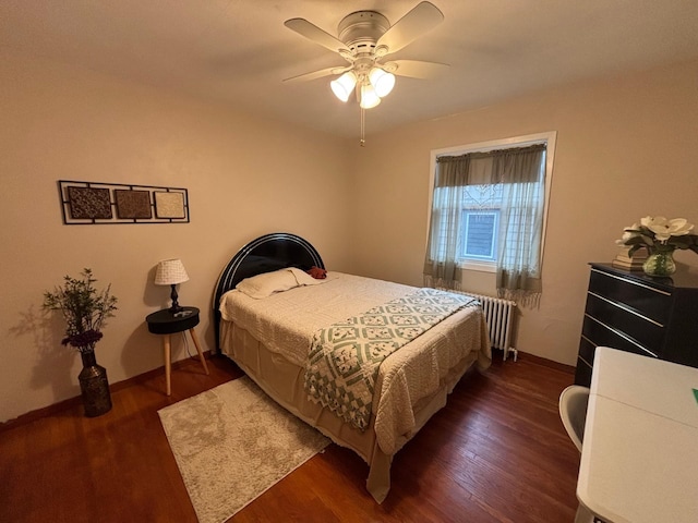 402 Brewster St, Harvey, ND 58341 - bedroom featuring baseboards, radiator, a ceiling fan, and wood finished floors