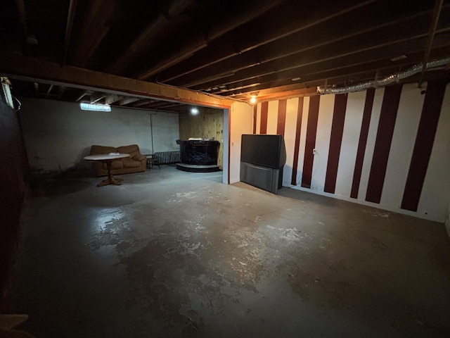 402 Brewster St, Harvey, ND 58341 - unfinished below grade area with a wood stove