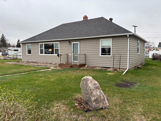 402 Brewster St, Harvey, ND 58341 - rear view of house featuring a chimney, a shingled roof, and a yard