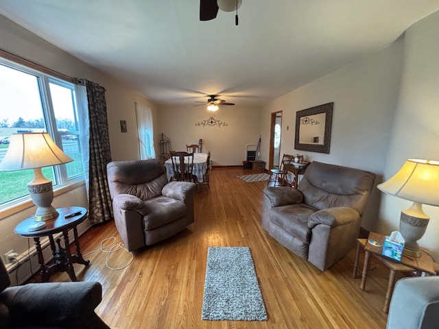 402 Brewster St, Harvey, ND 58341 - living room featuring wood finished floors, ceiling fan, and plenty of natural light