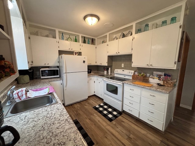 402 Brewster St, Harvey, ND 58341 - kitchen featuring a sink, light countertops, dark wood-style flooring, white appliances, and backsplash