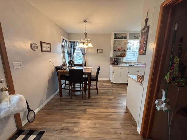 402 Brewster St, Harvey, ND 58341 - dining area with a wealth of natural light, wood finished floors, and a notable chandelier