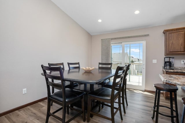 dining space with recessed lighting, baseboards, and wood finished floors
