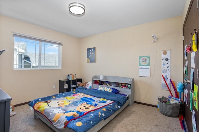 bedroom featuring baseboards and carpet