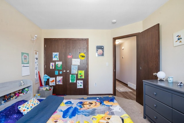 bedroom with baseboards and a closet