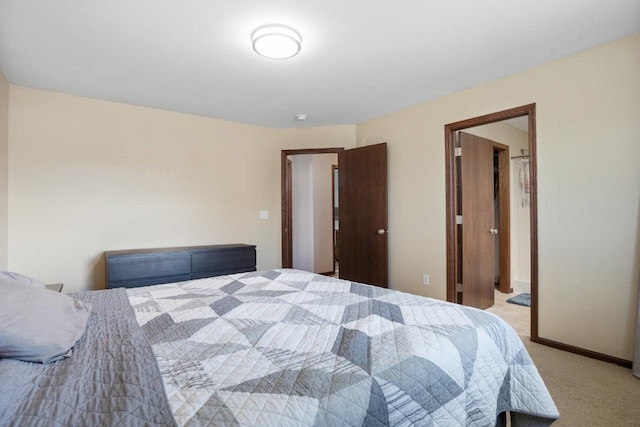 bedroom featuring light colored carpet and baseboards