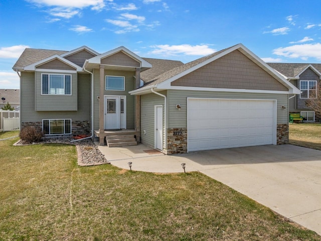 view of front facade with concrete driveway, a front lawn, stone siding, and a garage