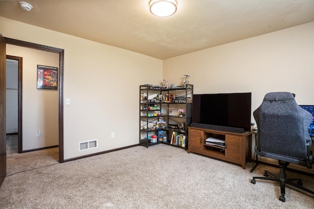 carpeted home office featuring visible vents and baseboards