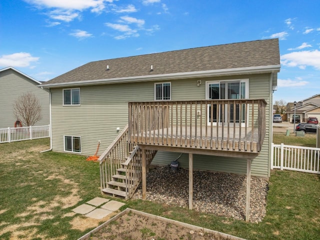 back of property with a fenced backyard, a deck, a yard, and stairway