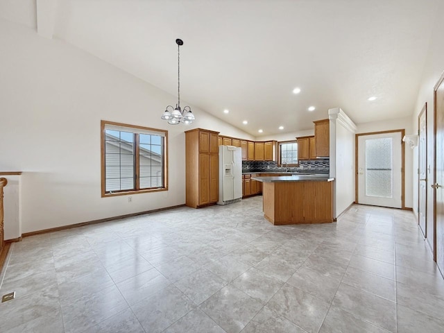 kitchen featuring recessed lighting, vaulted ceiling, white fridge with ice dispenser, and tasteful backsplash