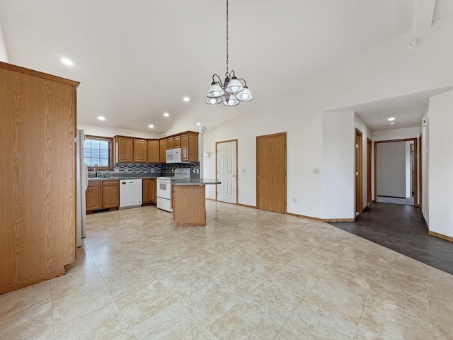 kitchen featuring white appliances, open floor plan, recessed lighting, a sink, and a notable chandelier
