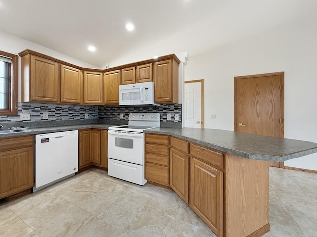 kitchen with white appliances, a peninsula, dark countertops, and backsplash