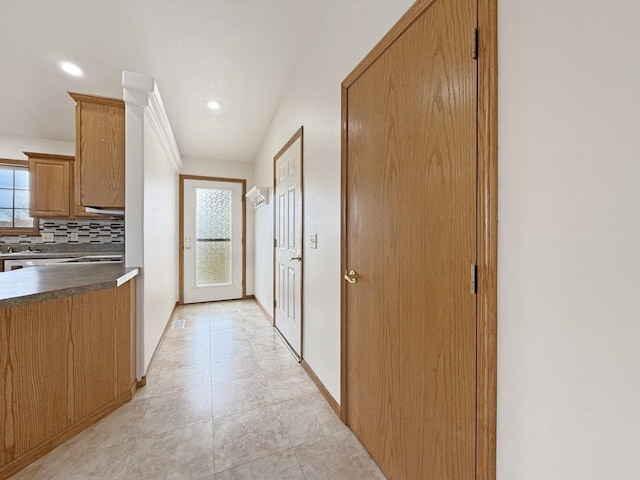 hallway featuring recessed lighting, baseboards, and light tile patterned floors