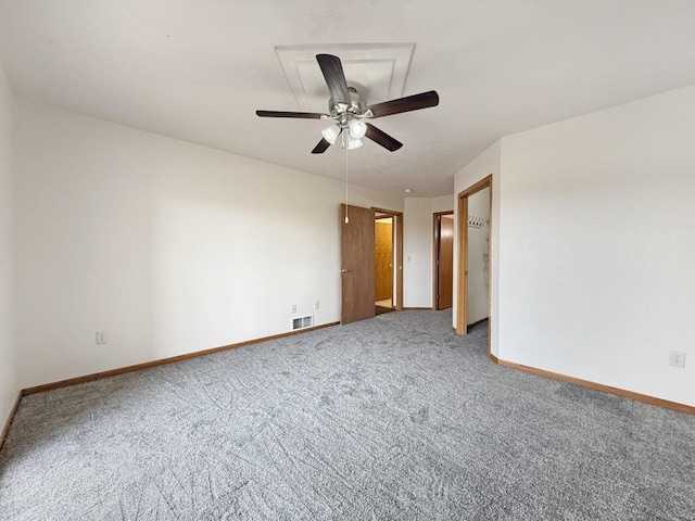 unfurnished room with a ceiling fan, baseboards, and carpet