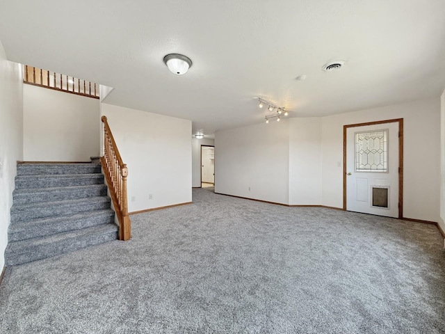unfurnished living room featuring carpet floors, baseboards, visible vents, and stairway