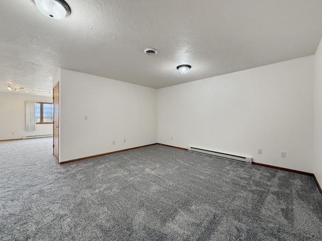 carpeted empty room featuring a textured ceiling, visible vents, baseboards, a baseboard radiator, and a baseboard heating unit