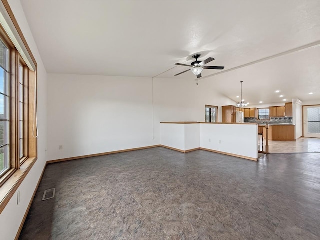 unfurnished living room featuring visible vents, recessed lighting, baseboards, and ceiling fan with notable chandelier