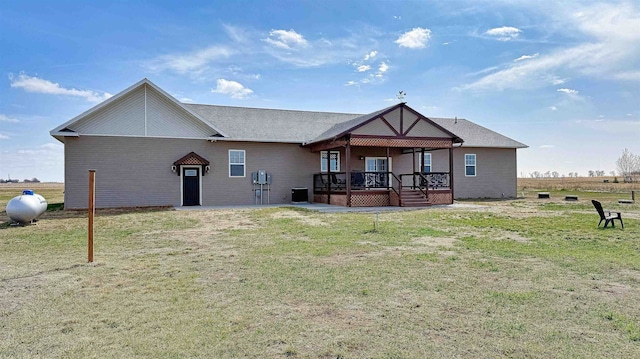 back of house with a yard, a deck, and central air condition unit