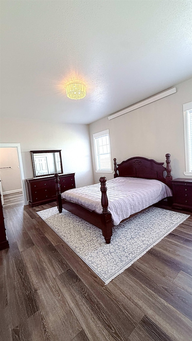 501 SW 135th Ave, Minot, ND 58701 - bedroom with dark wood-style floors and a textured ceiling