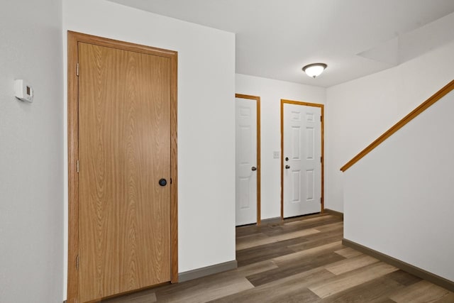 foyer featuring baseboards and wood finished floors