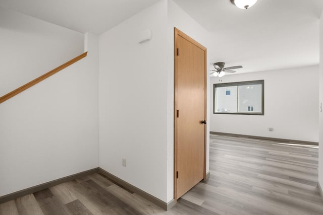 interior space with baseboards and light wood-type flooring
