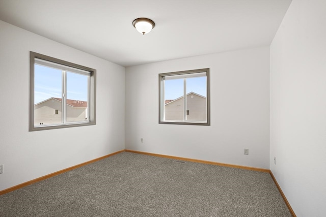 spare room with carpet flooring and baseboards